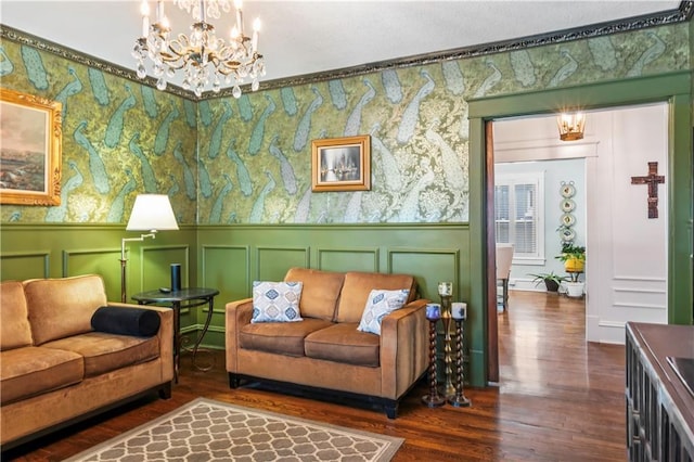 3215 Windsor Ave, Kansas City, MO 64123 - living area featuring wood finished floors, a chandelier, a wainscoted wall, and a decorative wall