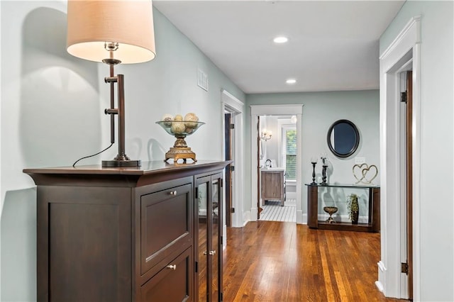 3215 Windsor Ave, Kansas City, MO 64123 - hall with dark wood-style floors and recessed lighting