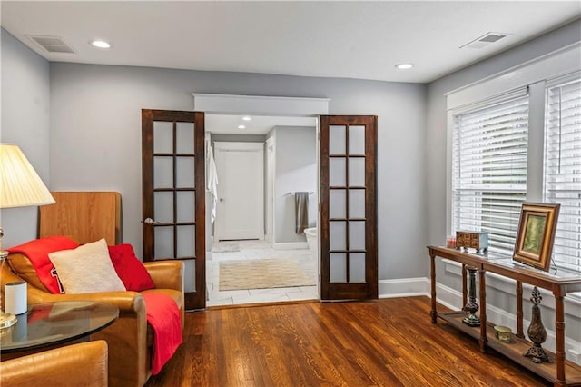 3215 Windsor Ave, Kansas City, MO 64123 - sitting room with wood finished floors, french doors, and recessed lighting