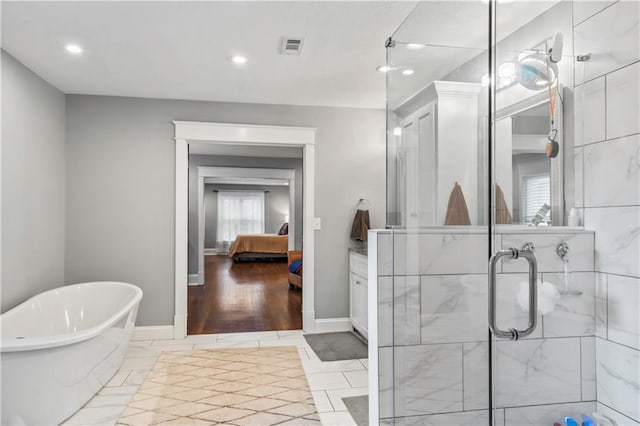 3215 Windsor Ave, Kansas City, MO 64123 - ensuite bathroom featuring a freestanding bath, a stall shower, recessed lighting, and vanity
