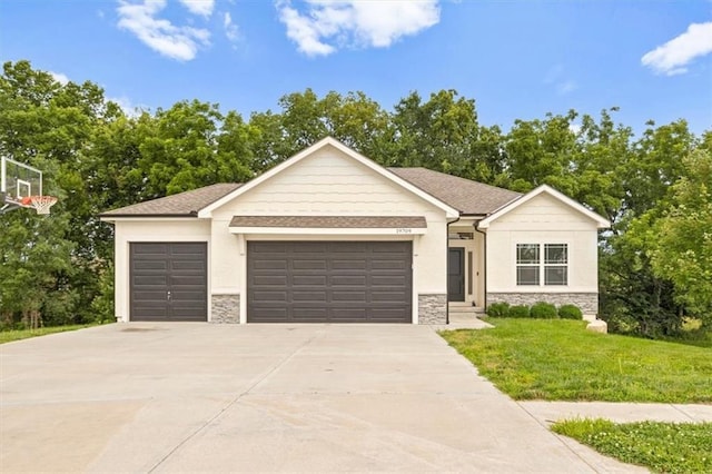 19709 W 198th Ct, Spring Hill, KS 66083 - view of front of home with stone siding, an attached garage, concrete driveway, and a front lawn