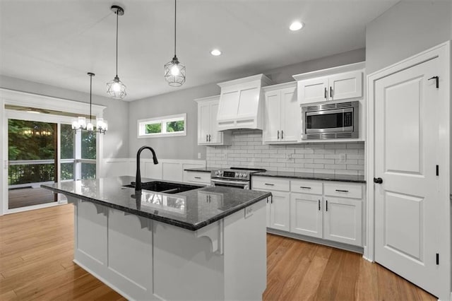 19709 W 198th Ct, Spring Hill, KS 66083 - kitchen with stainless steel appliances, custom exhaust hood, white cabinetry, recessed lighting, and decorative backsplash