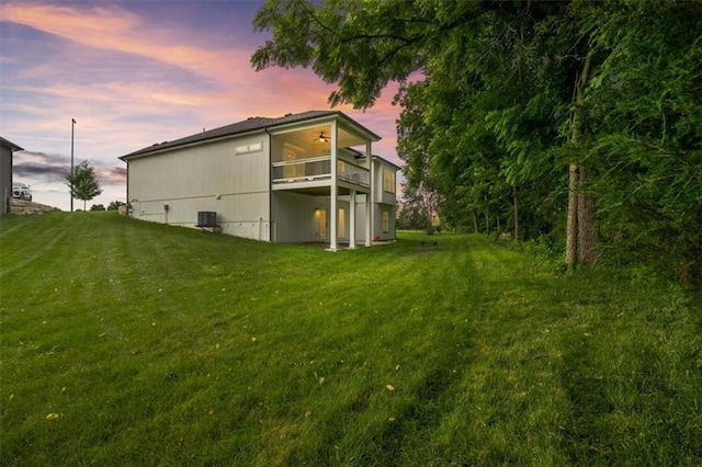 19709 W 198th Ct, Spring Hill, KS 66083 - property exterior at dusk featuring a lawn, a ceiling fan, and a balcony