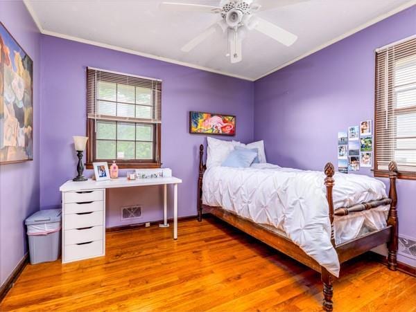 607 Green St, Lees Summit, MO 64063 - bedroom with wood finished floors, multiple windows, ornamental molding, and ceiling fan