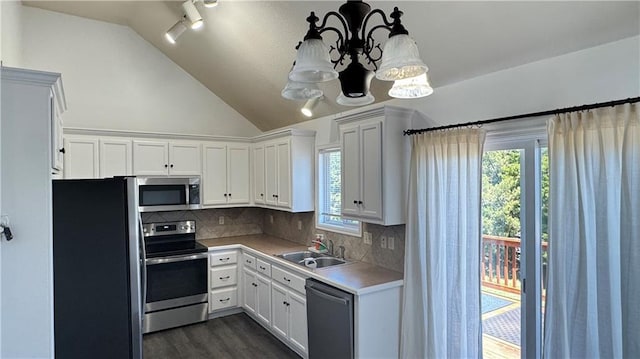 1725 N 57th Ter, Kansas City, KS 66102 - kitchen featuring appliances with stainless steel finishes, a chandelier, dark wood-type flooring, white cabinets, and lofted ceiling