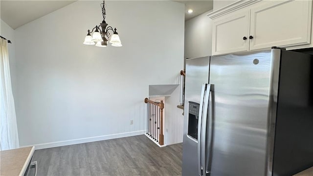 1725 N 57th Ter, Kansas City, KS 66102 - kitchen featuring stainless steel fridge, dark wood-style flooring, a chandelier, white cabinets, and pendant lighting