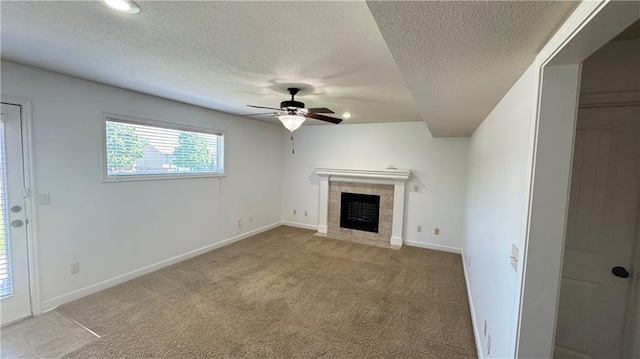 1725 N 57th Ter, Kansas City, KS 66102 - unfurnished living room with ceiling fan, a textured ceiling, a tile fireplace, carpet, and recessed lighting