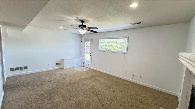 1725 N 57th Ter, Kansas City, KS 66102 - unfurnished room with light carpet, a ceiling fan, a textured ceiling, and recessed lighting