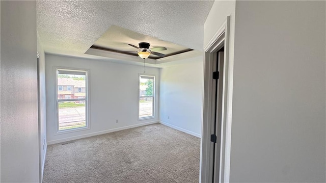 1725 N 57th Ter, Kansas City, KS 66102 - empty room with a tray ceiling, a textured ceiling, carpet, and ceiling fan