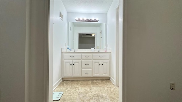 1725 N 57th Ter, Kansas City, KS 66102 - bathroom featuring double vanity and a textured ceiling