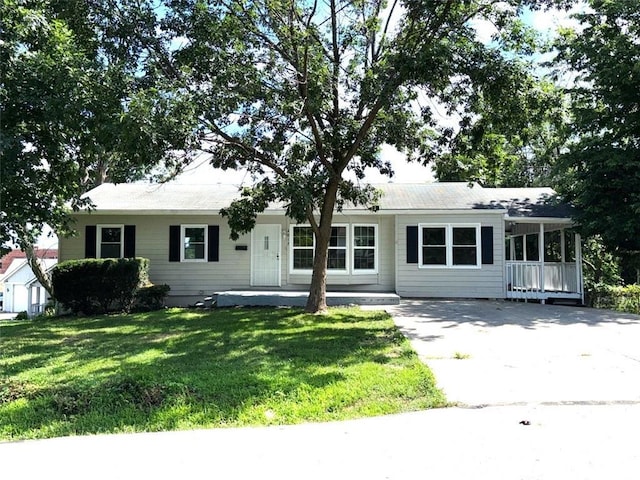 2017 E 83rd Ter, Kansas City, MO 64132 - single story home with concrete driveway, a front lawn, and a porch