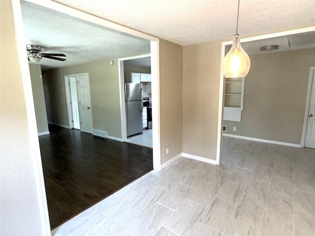 2017 E 83rd Ter, Kansas City, MO 64132 - spare room featuring a textured ceiling and ceiling fan