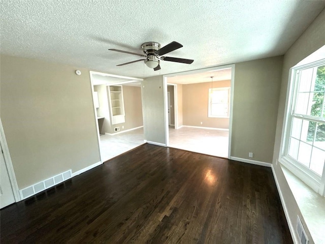 2017 E 83rd Ter, Kansas City, MO 64132 - empty room featuring a ceiling fan, a textured ceiling, and wood finished floors