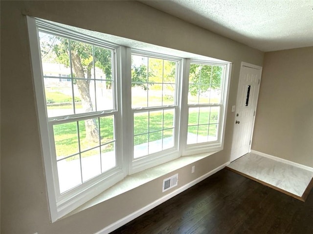 2017 E 83rd Ter, Kansas City, MO 64132 - entryway featuring dark wood finished floors and a textured ceiling