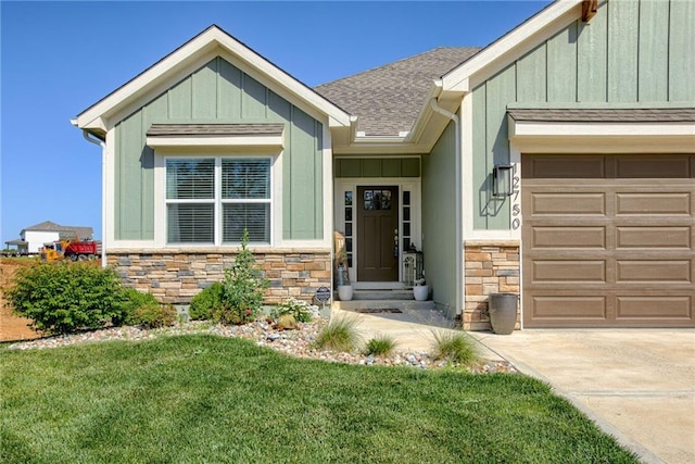 12750 Larkspur Ln, Platte City, MO 64079 - view of front of home featuring stone siding, board and batten siding, an attached garage, roof with shingles, and a front yard