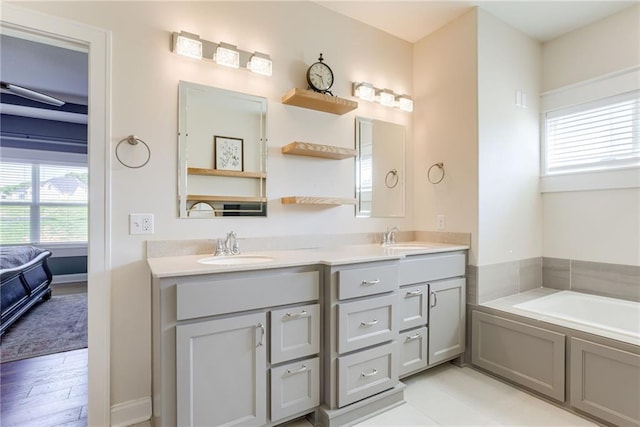 12750 Larkspur Ln, Platte City, MO 64079 - bathroom featuring healthy amount of natural light, double vanity, a garden tub, and ensuite bathroom