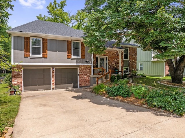 13924 S Summertree Ln, Olathe, KS 66062 - bi-level home featuring a garage, driveway, and brick siding