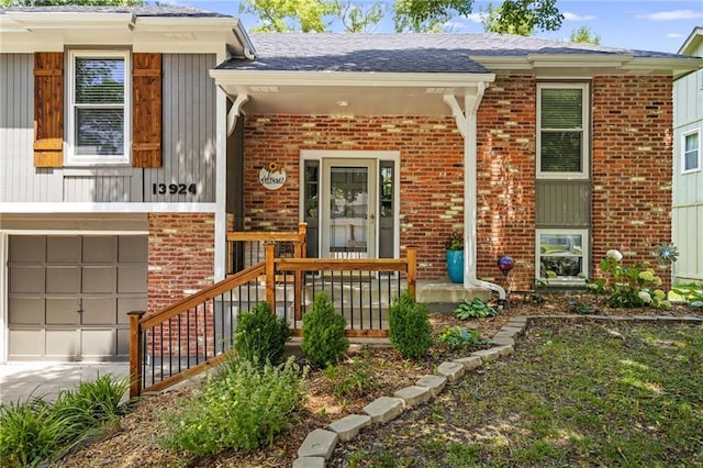13924 S Summertree Ln, Olathe, KS 66062 - view of front of house with brick siding, an attached garage, driveway, and a porch