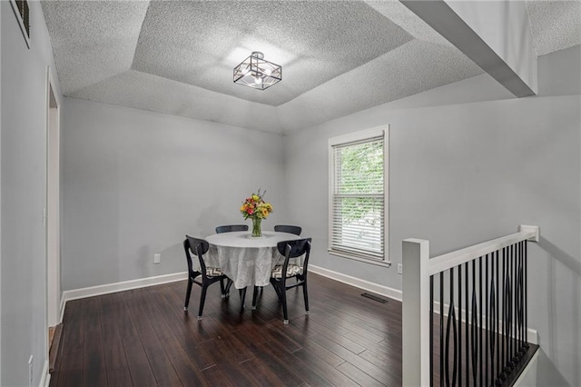 13924 S Summertree Ln, Olathe, KS 66062 - dining room with a textured ceiling and dark wood-type flooring