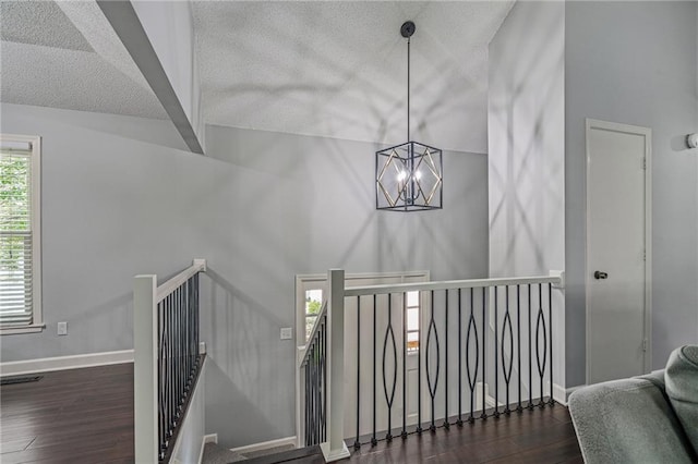 13924 S Summertree Ln, Olathe, KS 66062 - stairway with a chandelier, wood finished floors, and a textured ceiling