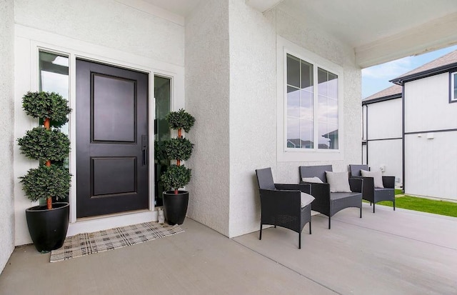 13404 W 177th St, Overland Park, KS 66013 - view of exterior entry featuring stucco siding and a patio