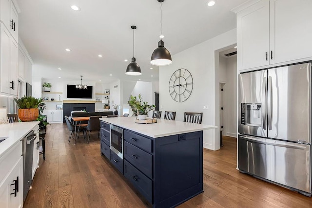 13404 W 177th St, Overland Park, KS 66013 - kitchen featuring appliances with stainless steel finishes, white cabinets, light countertops, dark wood finished floors, and recessed lighting