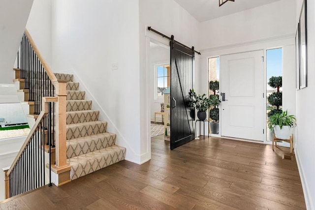 13404 W 177th St, Overland Park, KS 66013 - entryway featuring dark wood-style floors, stairs, and a barn door