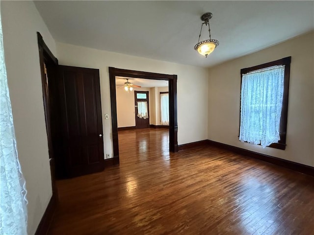 624 S St, Atchison, KS 66002 - spare room featuring dark wood-type flooring and baseboards