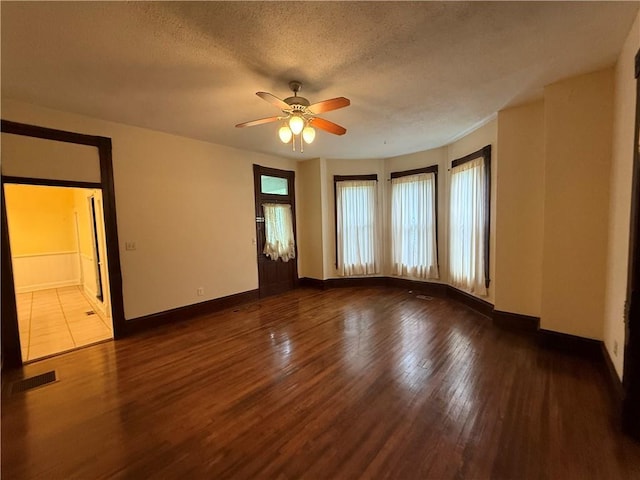 624 S St, Atchison, KS 66002 - spare room featuring wood finished floors, ceiling fan, and a textured ceiling
