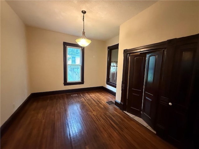 624 S St, Atchison, KS 66002 - unfurnished dining area featuring dark wood-style floors and baseboards