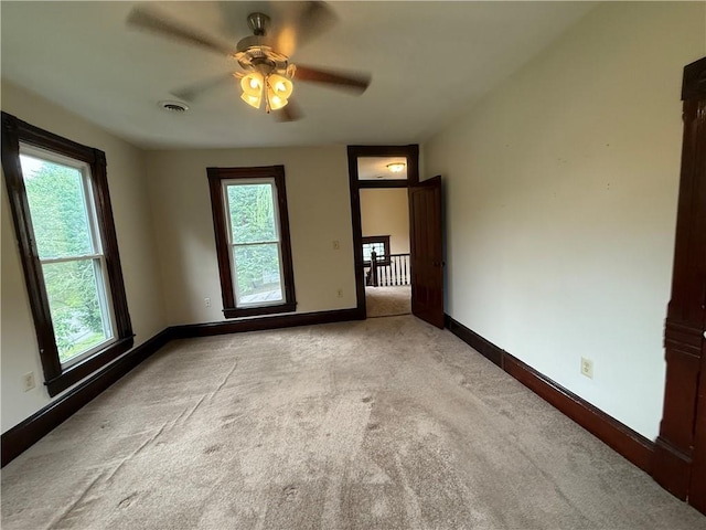 624 S St, Atchison, KS 66002 - unfurnished room featuring healthy amount of natural light, light carpet, and a ceiling fan