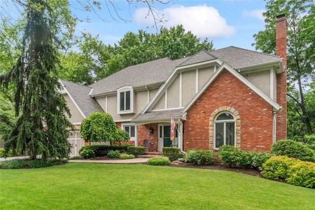 2405 W 124th St, Leawood, KS 66209 - tudor house with stucco siding, a chimney, a front lawn, and brick siding