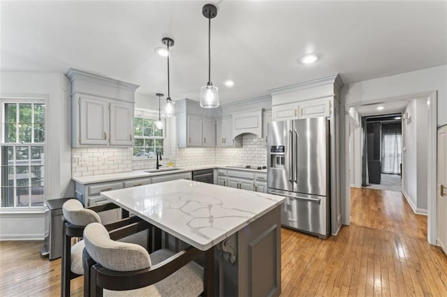 2405 W 124th St, Leawood, KS 66209 - kitchen with appliances with stainless steel finishes, gray cabinets, light wood-type flooring, tasteful backsplash, and recessed lighting