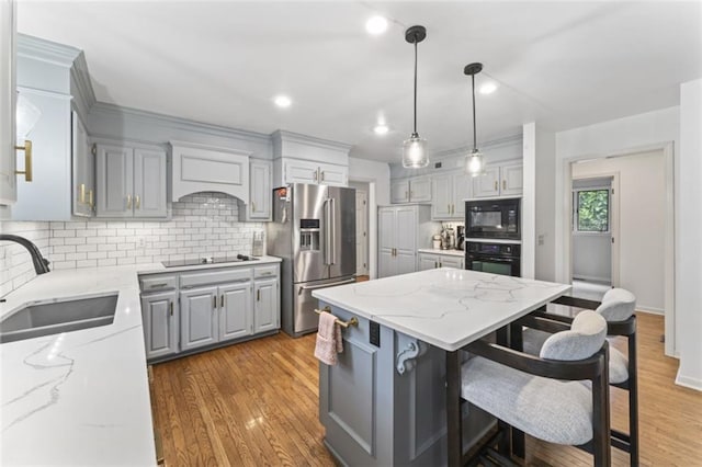 2405 W 124th St, Leawood, KS 66209 - kitchen with black appliances, gray cabinets, a kitchen island, custom exhaust hood, and decorative backsplash