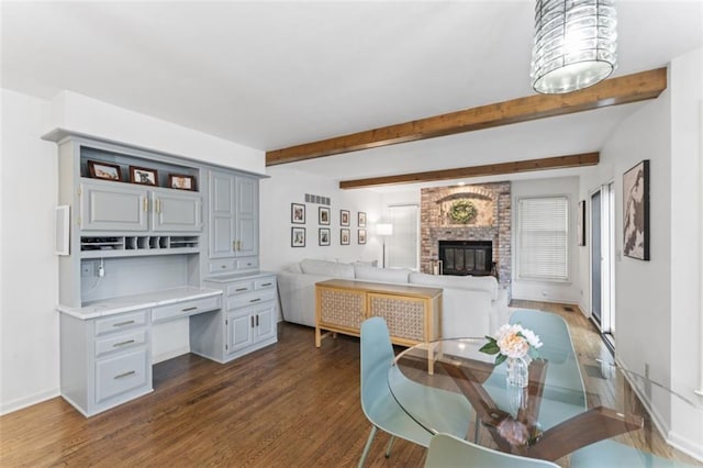 2405 W 124th St, Leawood, KS 66209 - dining room featuring dark wood finished floors, beamed ceiling, and a fireplace