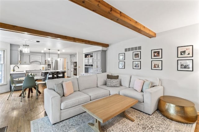2405 W 124th St, Leawood, KS 66209 - living area featuring beamed ceiling and light wood finished floors