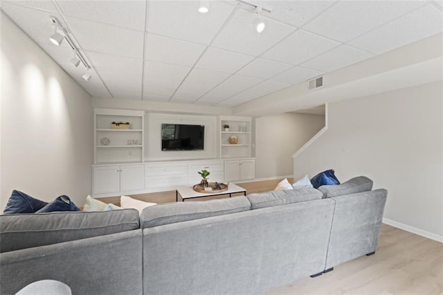 2405 W 124th St, Leawood, KS 66209 - living area featuring track lighting, light wood-type flooring, built in shelves, and stairs