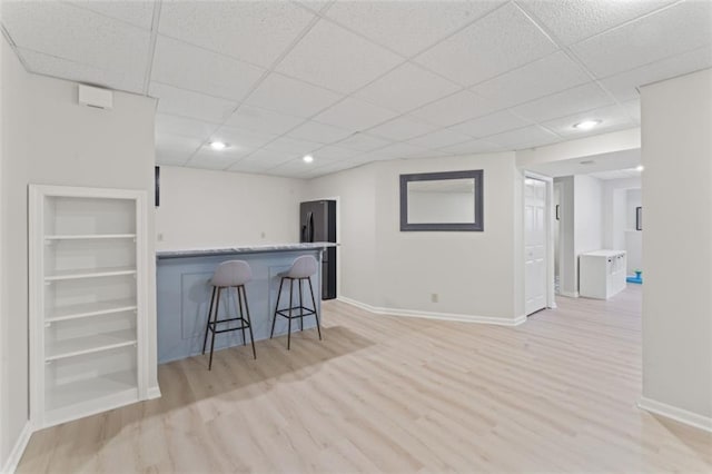 2405 W 124th St, Leawood, KS 66209 - kitchen with a drop ceiling, a breakfast bar, light wood-type flooring, recessed lighting, and built in shelves