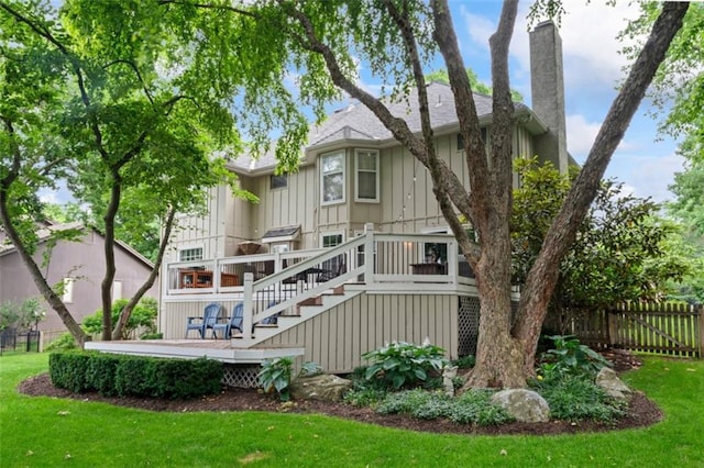 2405 W 124th St, Leawood, KS 66209 - rear view of house featuring stairs, board and batten siding, a deck, and a chimney