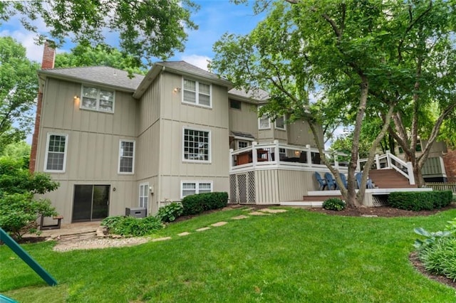 2405 W 124th St, Leawood, KS 66209 - back of property featuring a chimney, a wooden deck, and a lawn
