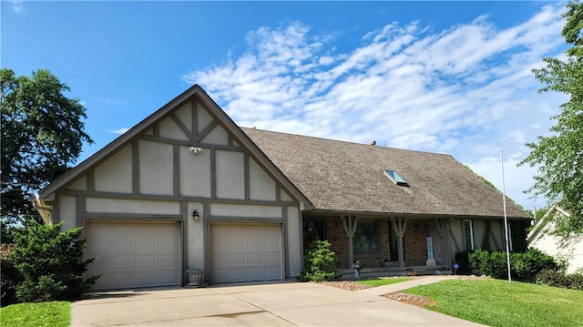 16904 E 36th St S, Independence, MO 64055 - tudor home with a garage, concrete driveway, a shingled roof, a front yard, and covered porch