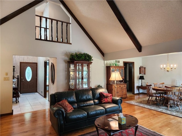 16904 E 36th St S, Independence, MO 64055 - living room featuring high vaulted ceiling, a chandelier, beamed ceiling, and light wood-style floors