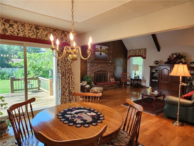 16904 E 36th St S, Independence, MO 64055 - dining space with wood finished floors, a chandelier, and a fireplace
