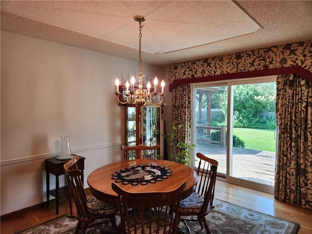 16904 E 36th St S, Independence, MO 64055 - dining area with a chandelier, a textured ceiling, and wood finished floors