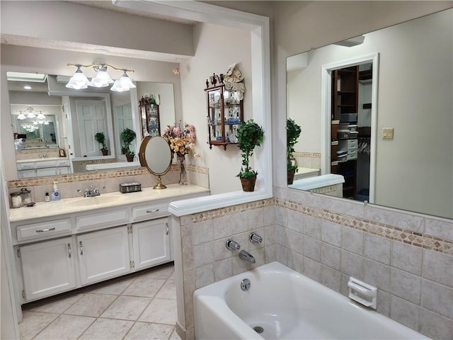 16904 E 36th St S, Independence, MO 64055 - bathroom with a chandelier, a bath, vanity, backsplash, and tile patterned flooring