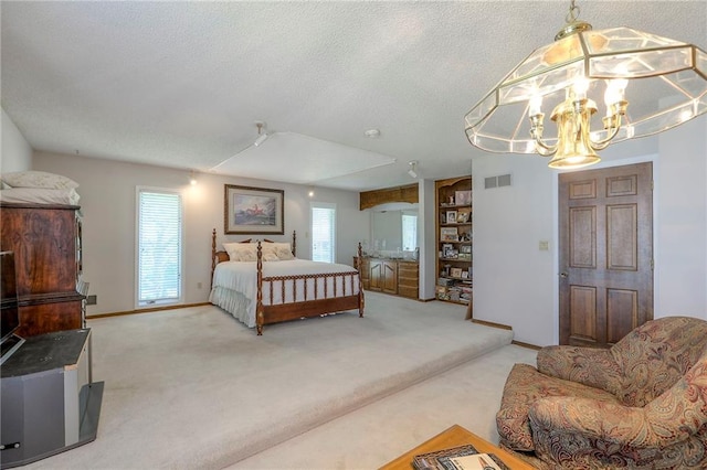 16904 E 36th St S, Independence, MO 64055 - carpeted bedroom with multiple windows, a chandelier, and a textured ceiling