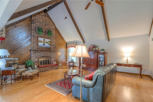 16904 E 36th St S, Independence, MO 64055 - living area featuring beamed ceiling, wood finished floors, a brick fireplace, a ceiling fan, and high vaulted ceiling