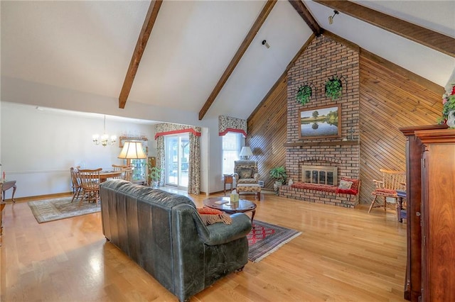 16904 E 36th St S, Independence, MO 64055 - living room with high vaulted ceiling, wood walls, a brick fireplace, a chandelier, and beam ceiling