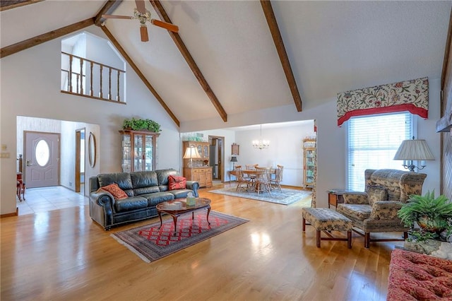 16904 E 36th St S, Independence, MO 64055 - living area with high vaulted ceiling, a chandelier, a ceiling fan, light wood-style floors, and beamed ceiling