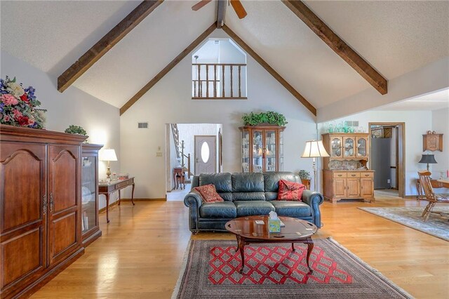 16904 E 36th St S, Independence, MO 64055 - living room with high vaulted ceiling, beamed ceiling, light wood-type flooring, and a ceiling fan